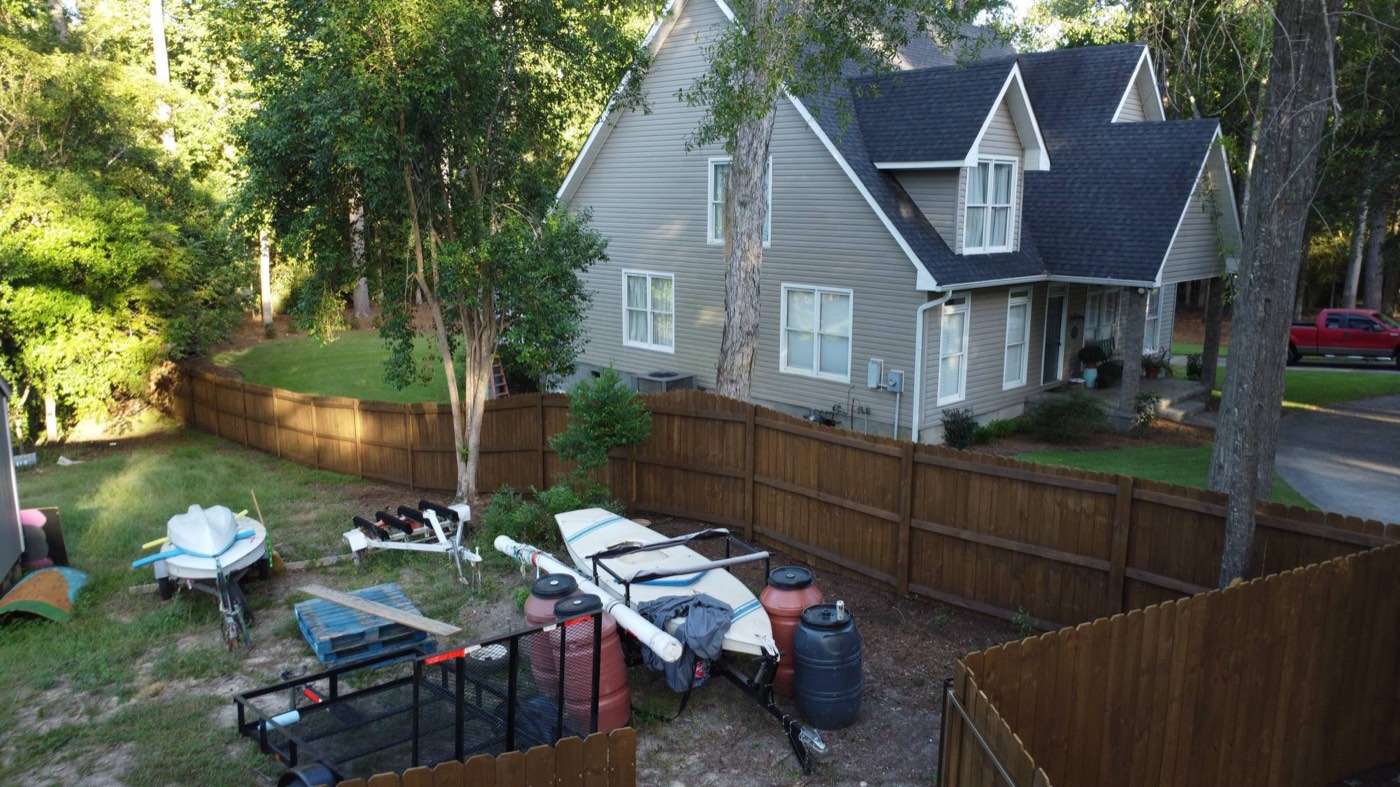 Aerial view of a wood privacy fence stained dark brown by Southern Residential Fence Company