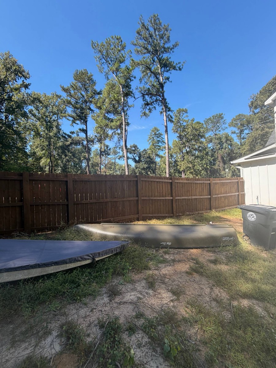 Backyard wood privacy fence with fresh brown stain